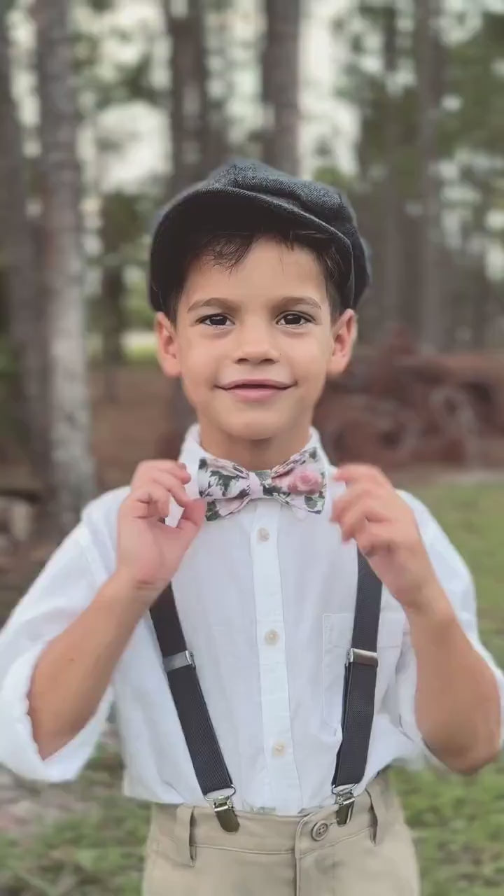 beige bow tie and suspenders